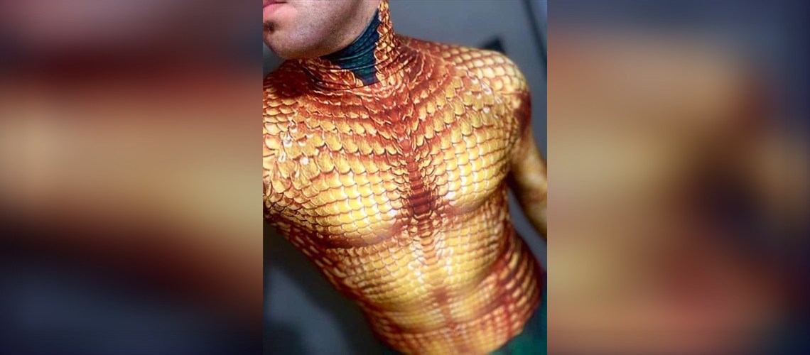 Dye Sublimation vs Screen Printing for Cosplay: Which One Wins? 1 Close-up of a gold dragon scale dye sublimation cosplay suit chest with detailed printed texture, shown on a wide banner with a blurred background.